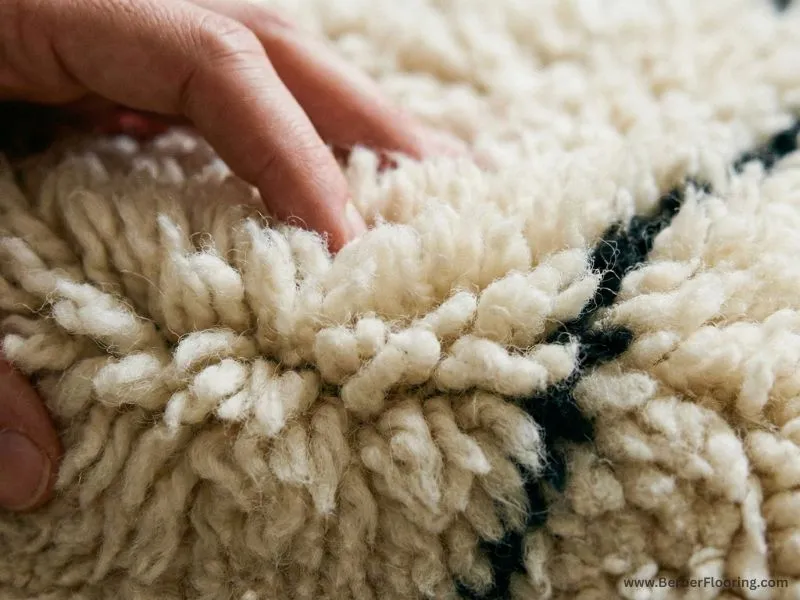 Close-up view of the thick, plush wool pile texture of an authentic Moroccan shag rug.